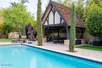 view of swimming pool with a patio and a gazebo