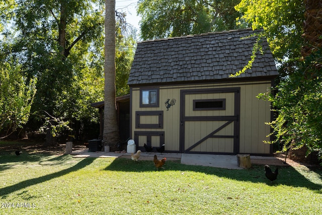 view of outdoor structure featuring a lawn