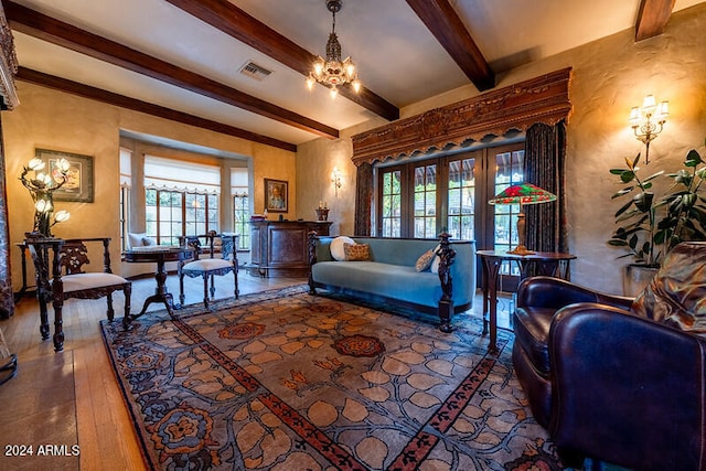 living room featuring french doors, a chandelier, beamed ceiling, and wood-type flooring