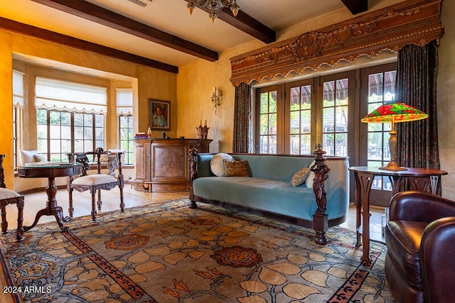 living area with beam ceiling, french doors, and plenty of natural light