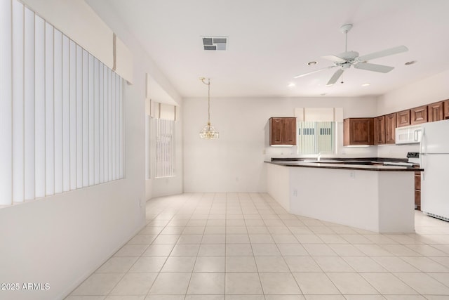 14609 W Black Gold Ln, Sun City West, AZ 85375 - kitchen with white appliances, dark countertops, a peninsula, decorative light fixtures, and ceiling fan