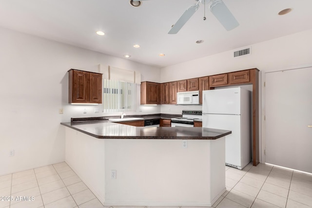 14609 W Black Gold Ln, Sun City West, AZ 85375 - kitchen with white appliances, dark countertops, a sink, a peninsula, and recessed lighting