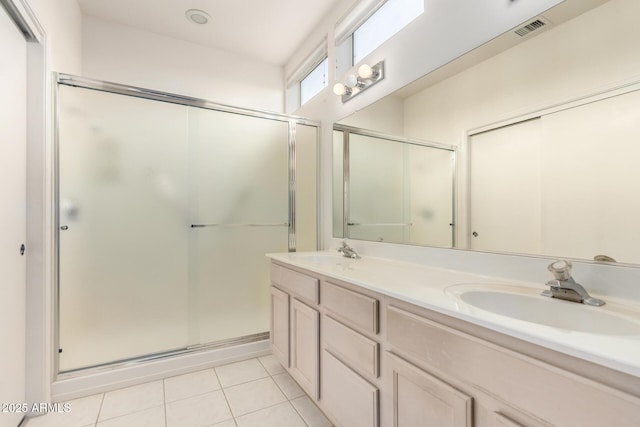 14609 W Black Gold Ln, Sun City West, AZ 85375 - bathroom with double vanity, a shower stall, and tile patterned flooring