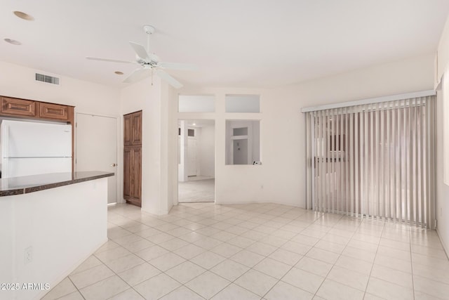 14609 W Black Gold Ln, Sun City West, AZ 85375 - spare room featuring a ceiling fan and light tile patterned floors