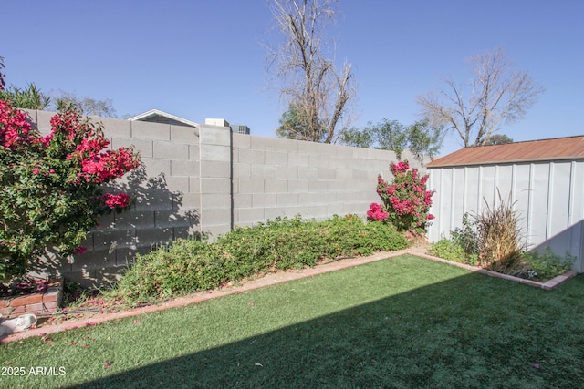 view of yard featuring an outbuilding and a fenced backyard