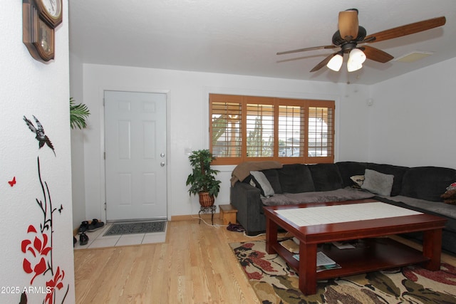 living room featuring ceiling fan and light wood-style flooring