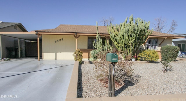 view of front of house featuring an attached carport and driveway