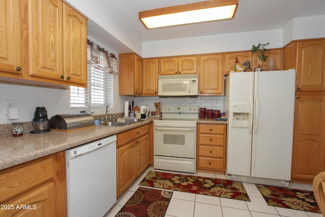 kitchen with light tile patterned floors, light countertops, backsplash, a sink, and white appliances