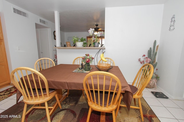 dining space with light tile patterned floors, baseboards, and visible vents