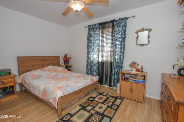 bedroom featuring light wood-style floors, ceiling fan, and baseboards