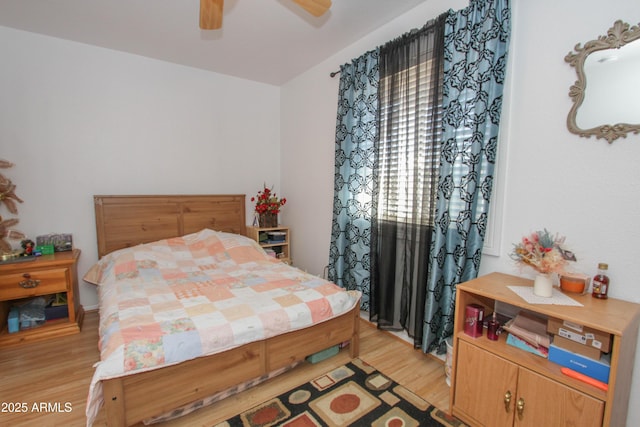 bedroom with light wood finished floors and a ceiling fan