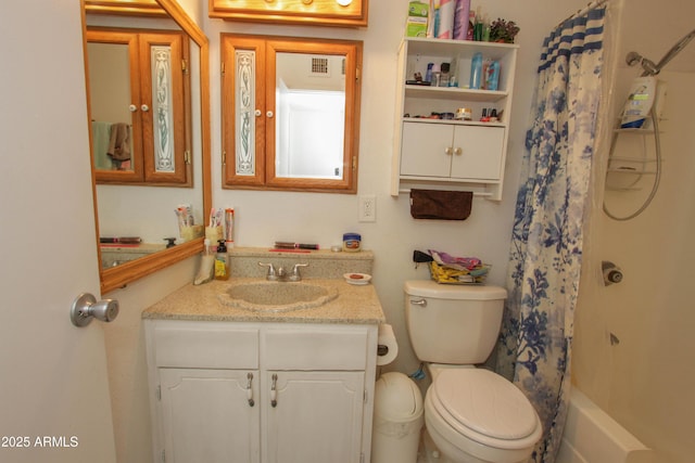 bathroom featuring toilet, vanity, and visible vents