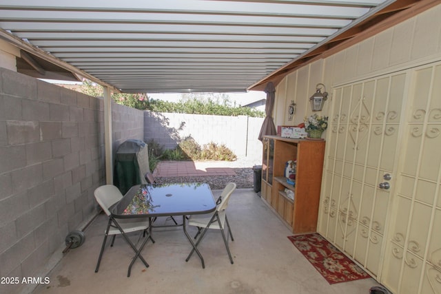 view of patio / terrace with outdoor dining space, a fenced backyard, and area for grilling