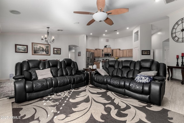 living room with crown molding, light hardwood / wood-style floors, and ceiling fan with notable chandelier