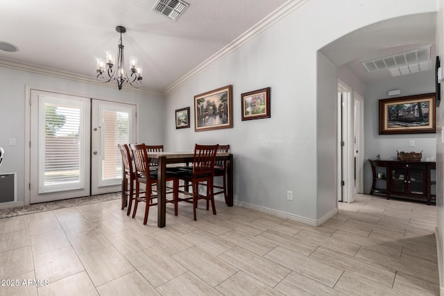 dining area with french doors, vaulted ceiling, an inviting chandelier, and crown molding