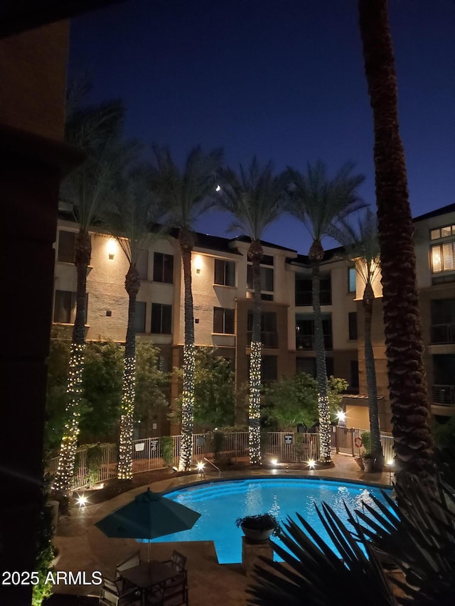 pool at twilight with a patio