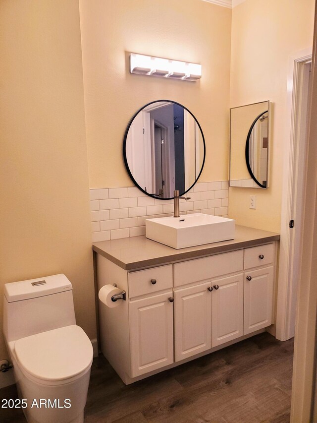 bathroom featuring hardwood / wood-style flooring, backsplash, toilet, and vanity