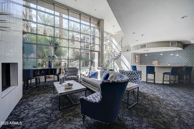 living room with carpet floors and expansive windows