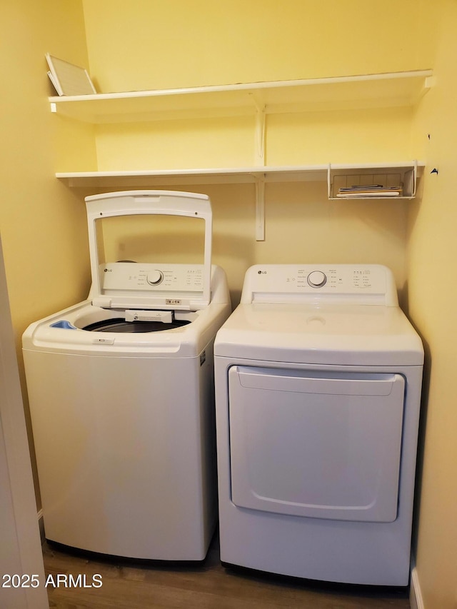 laundry room featuring washing machine and dryer and dark hardwood / wood-style floors