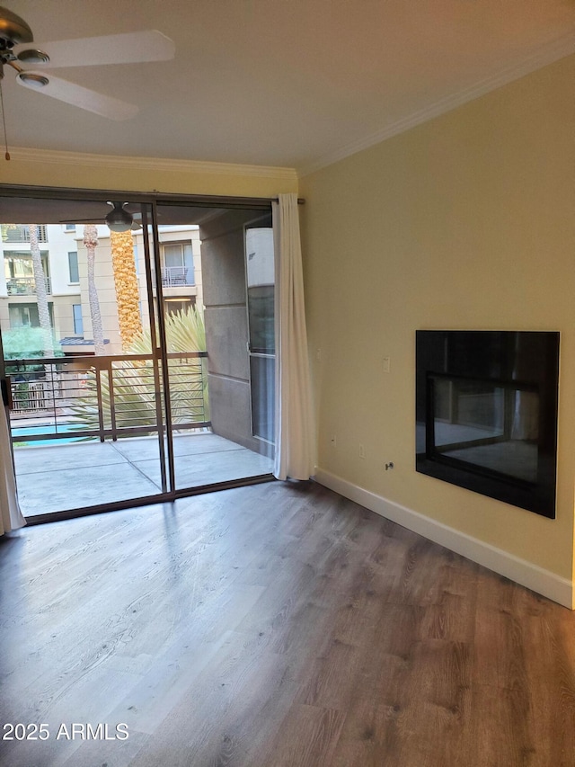 empty room featuring crown molding, hardwood / wood-style flooring, and ceiling fan