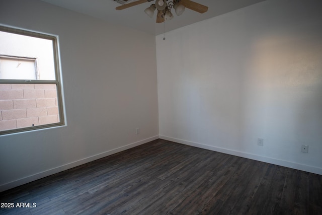 unfurnished room featuring ceiling fan, dark wood-style flooring, and baseboards