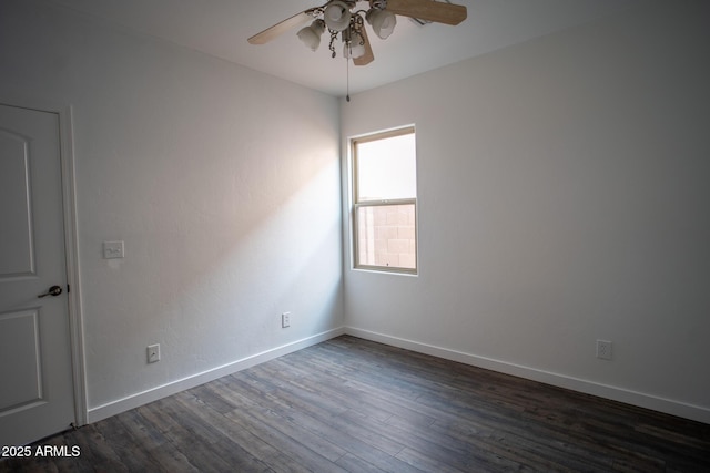 unfurnished room featuring ceiling fan, dark wood finished floors, and baseboards