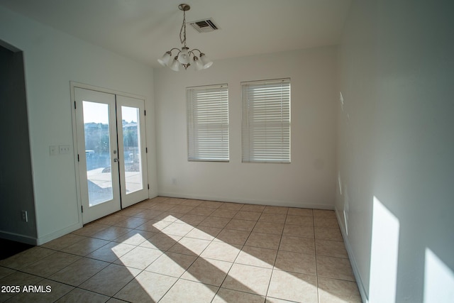 unfurnished dining area featuring light tile patterned floors, visible vents, french doors, and baseboards