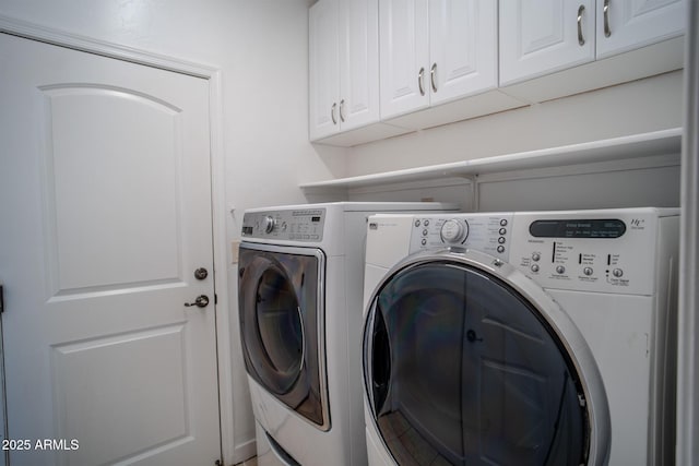 laundry area featuring independent washer and dryer and cabinet space