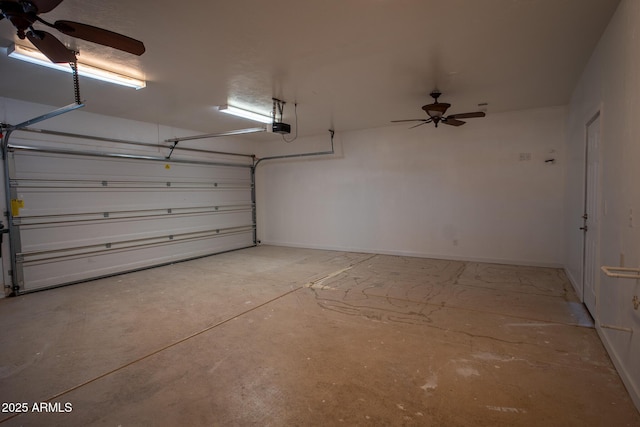 garage with ceiling fan, a garage door opener, and baseboards