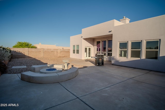 exterior space with a fire pit, a fenced backyard, and area for grilling