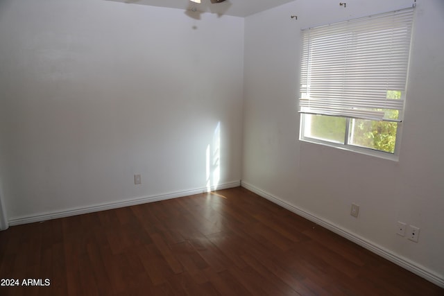 spare room featuring ceiling fan and dark hardwood / wood-style flooring