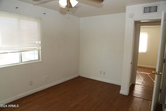 empty room featuring ceiling fan and dark wood-type flooring