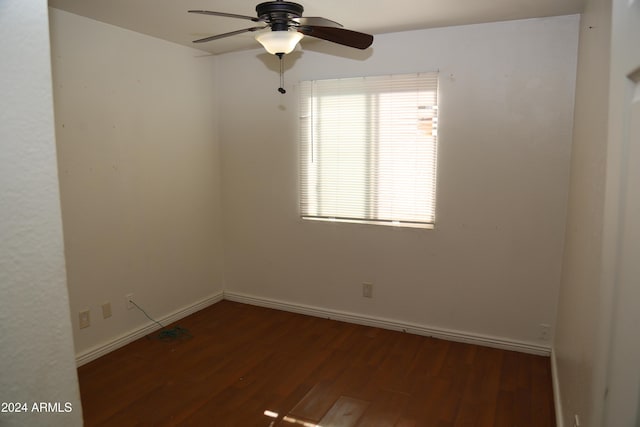 spare room featuring dark hardwood / wood-style flooring and ceiling fan