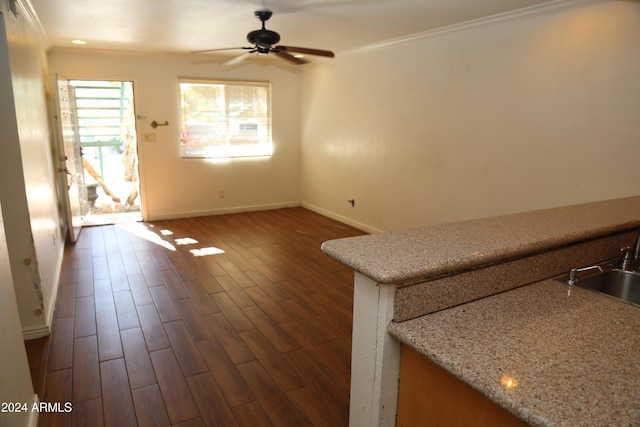 unfurnished living room with dark hardwood / wood-style flooring, ceiling fan, and crown molding