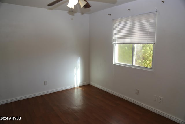 empty room featuring dark hardwood / wood-style flooring and ceiling fan