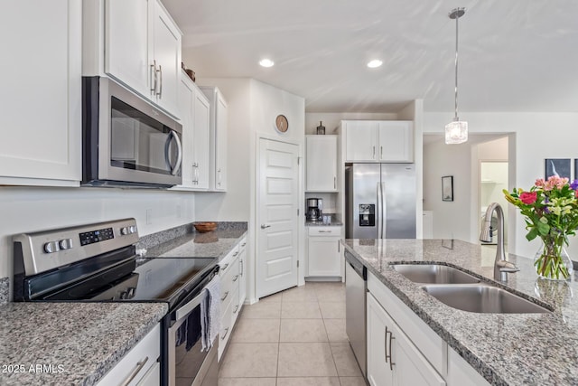 kitchen with a sink, appliances with stainless steel finishes, and white cabinetry