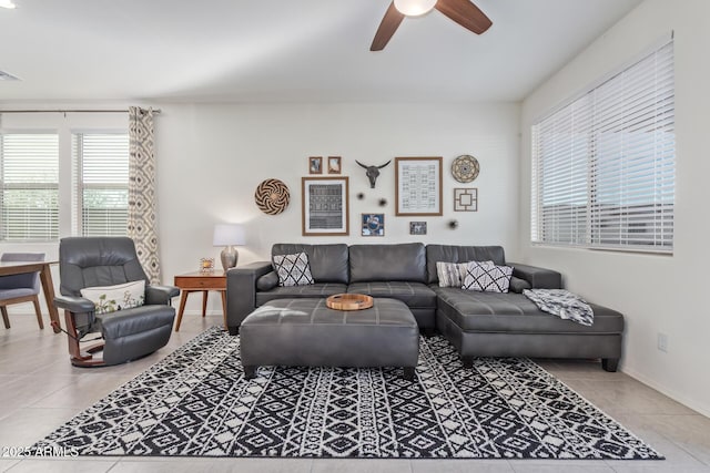 tiled living room featuring visible vents, baseboards, and a ceiling fan