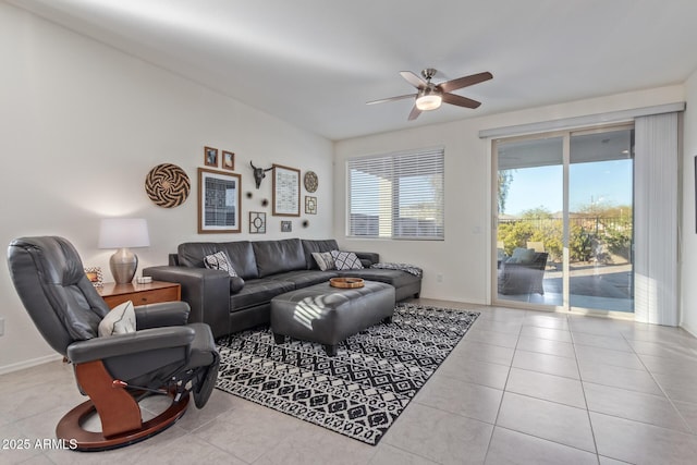 living room with tile patterned floors, baseboards, and ceiling fan