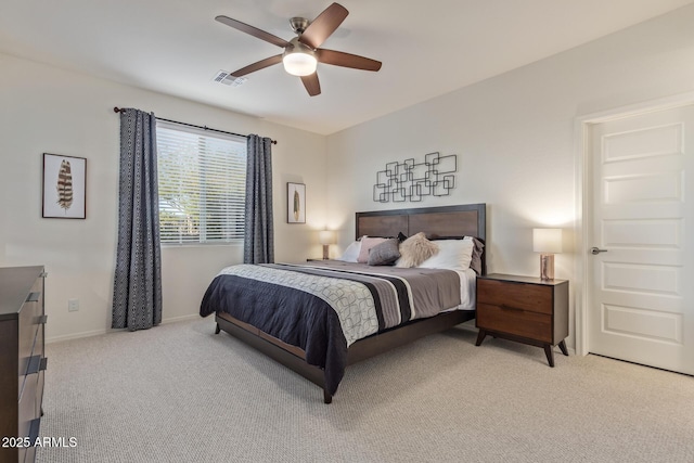 bedroom featuring visible vents, baseboards, light colored carpet, and ceiling fan