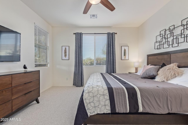 carpeted bedroom featuring baseboards, visible vents, and ceiling fan