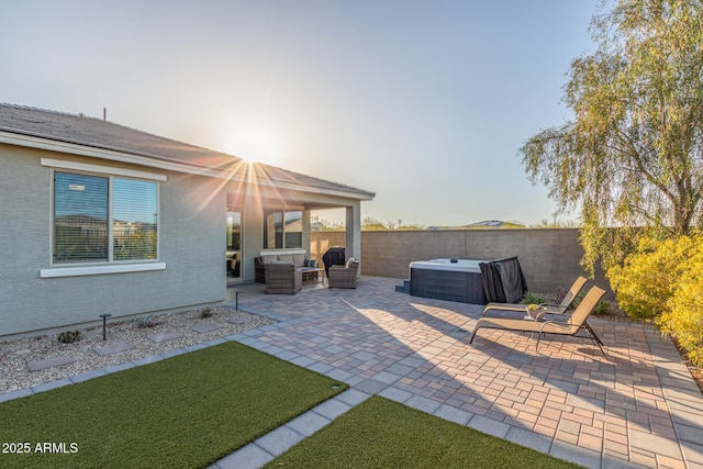 view of patio / terrace featuring an outdoor living space, a fenced backyard, and a hot tub