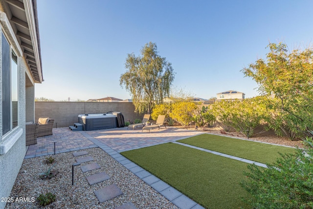 view of yard featuring a patio, a hot tub, and a fenced backyard