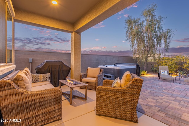 view of patio featuring an outdoor living space with a fire pit, a grill, a fenced backyard, and a hot tub