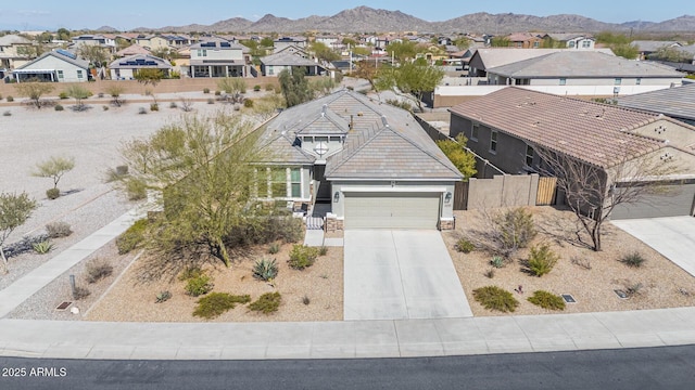 birds eye view of property with a mountain view and a residential view