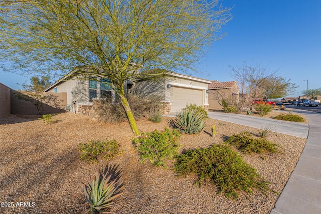 view of front of home featuring stucco siding, an attached garage, and concrete driveway