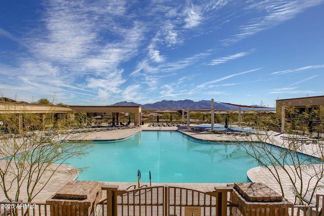 community pool with a patio area and a mountain view