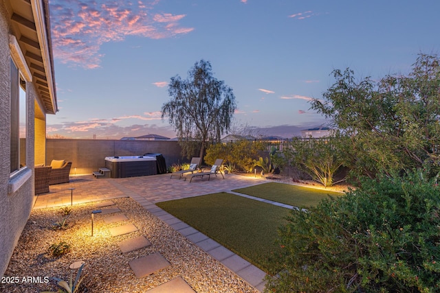 view of yard with a patio area, a hot tub, and a fenced backyard