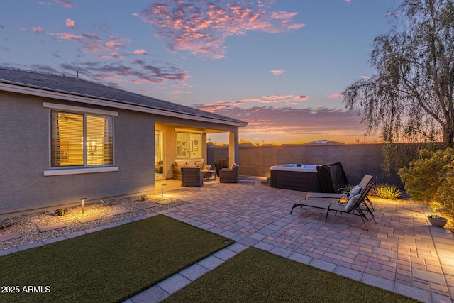 view of patio / terrace featuring a fenced backyard, outdoor lounge area, and a hot tub