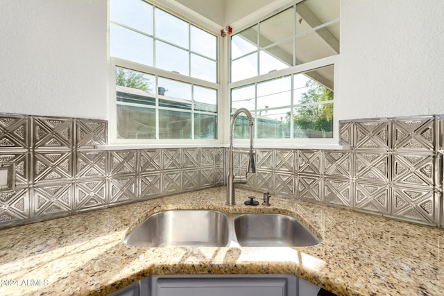 interior details with stone countertops and sink