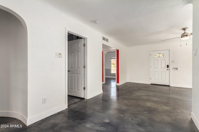 empty room featuring a textured ceiling and ceiling fan